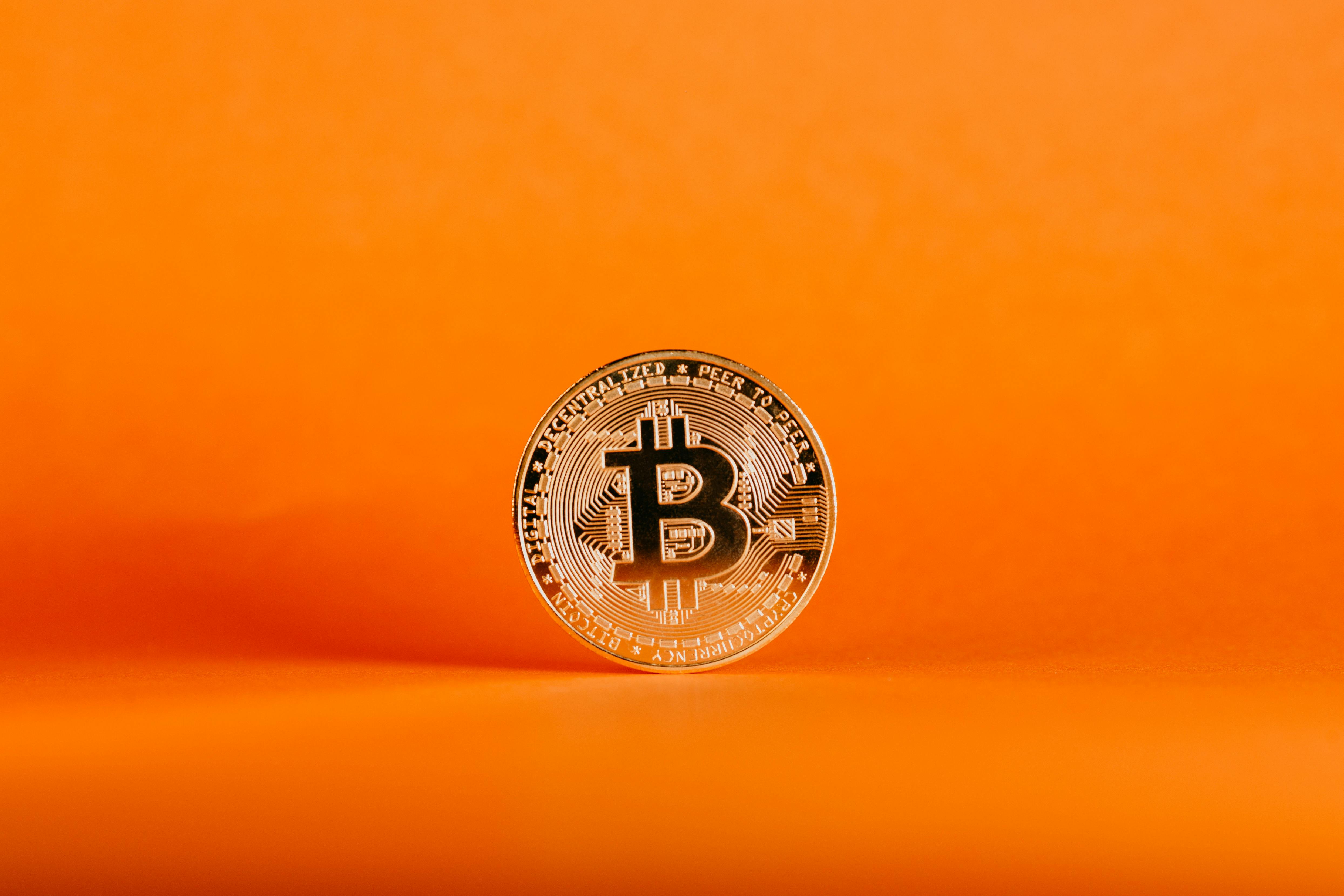 Golden Bitcoin in Orange Background · Free Stock Photo